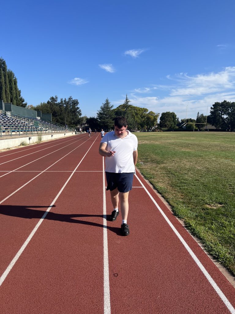 adult with developmental disability walking on track